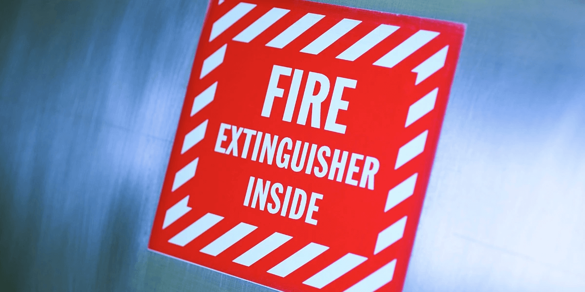 A sign in red saying fire extinguisher inside